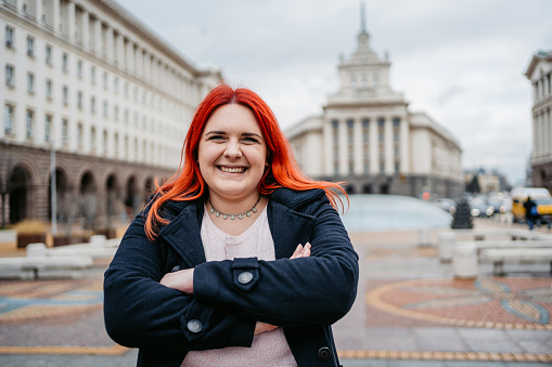 Portrait of a young plus size woman on the town square in Sofia, Bulgaria.