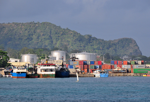 Moroni, Grande Comore / Ngazidja, Comoros islands: Comores Hydrocarbures oil depot / tank farm and ships and containers in the port. The Union of the Comoros does not have a refinery, therefore it imports all refined fuels it needs, shortages are common.