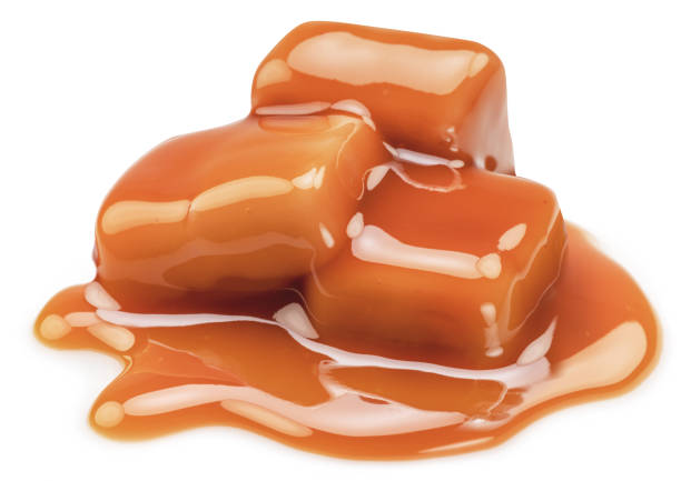 istock Caramel candies covered with melt caramel isolated on white background. 1490642814