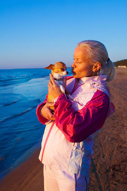 istock Young woman with her dog on a beach 149064363