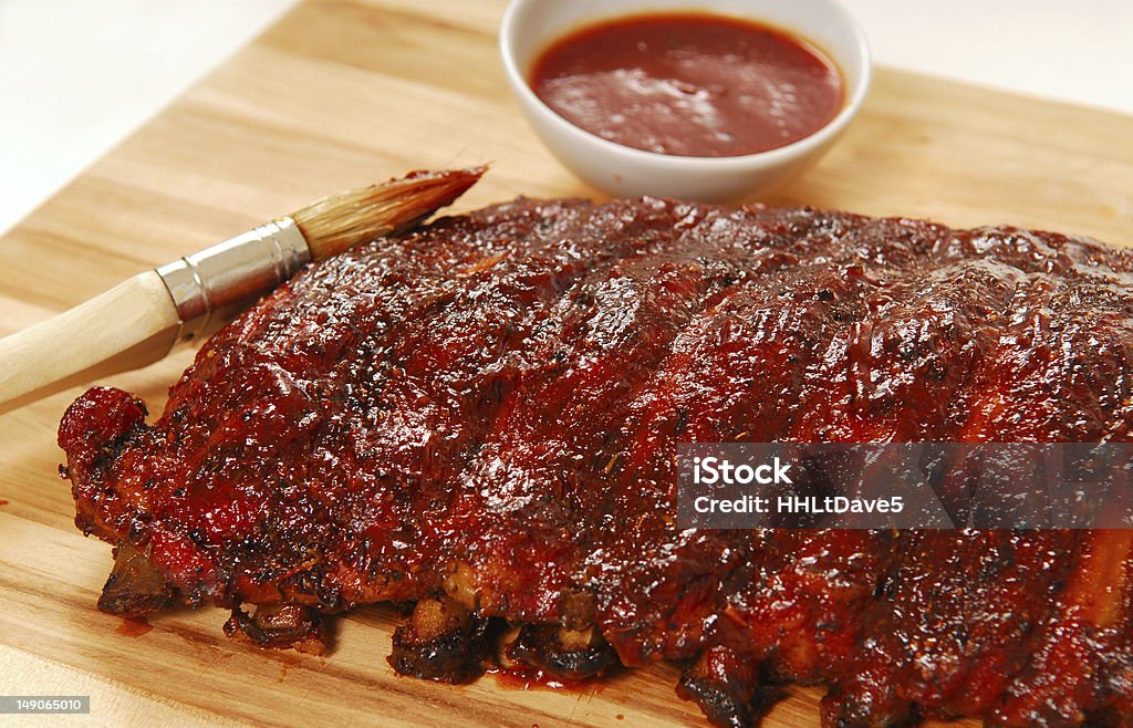 Slab of BBQ spare ribs Slab of freshly grilled BBQ spare ribs with dipping sauce Barbecue - Meal Stock Photo