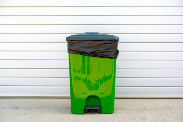 istock Green plastic garbage container standing in the street 1490652490
