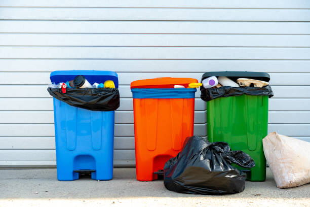 istock Three trash containers full of garbage near the building 1490652587