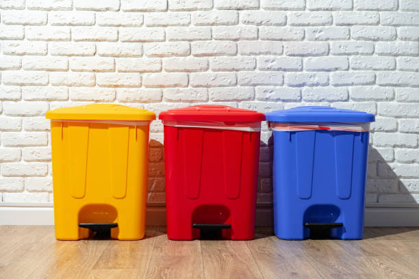 istock Three plastic trash bins against the wall in the building 1490652589