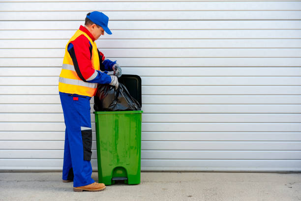 istock Janitor takes garbage out of trash container outdoors 1490652612
