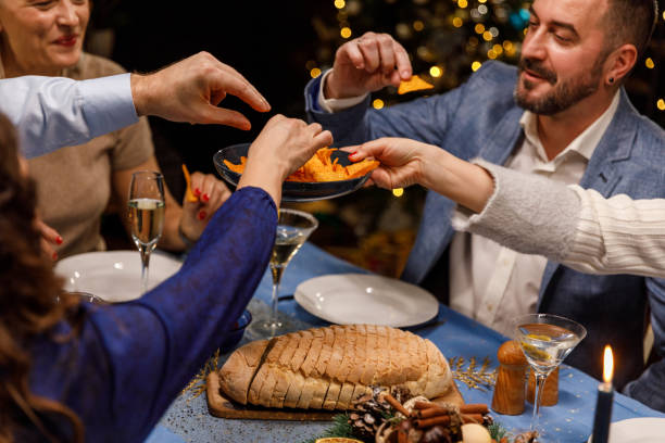 istock Friends taking tortilla chips as appetizer before enjoying delicious food during a Christmas dinner party 1490653361