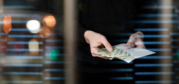 The concept of black cash in an envelope. stock photo