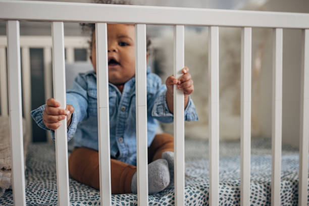 istock Baby boy sitting in a crib 1490654879