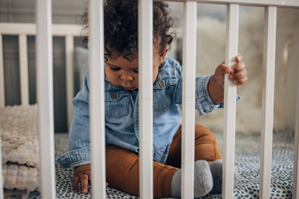 istock Baby boy sitting in a crib 1490654937