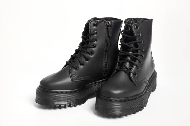 istock Black women combat boots on high heel platform with lug soles on isolated white background 1490655052