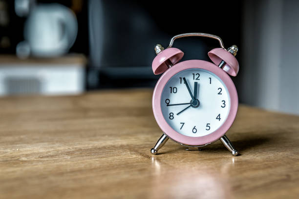 istock Vintage classic retro alarm clock on table 1490655858