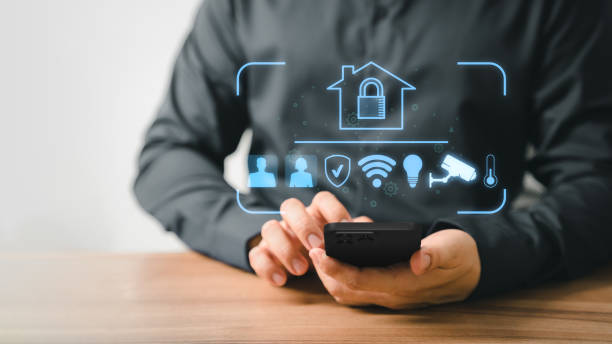 istock Adult man controlling technology AI smart home devices using a smartphone with launched application in the living room. Iot smart home automation app concept. 1490656159