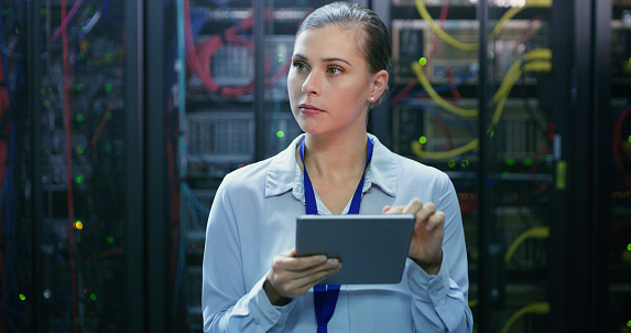 Tablet, woman and technician check server room for cloud computing or cyber security at night. Tech, it engineer and female person working on database for maintenance or networking in data center