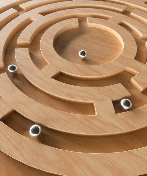 istock Ball bearing on a wooden maze puzzle 3d render 1490657448