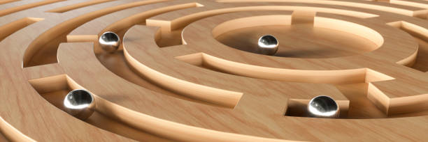 istock Ball bearing on a wooden maze puzzle 3d render 1490657826