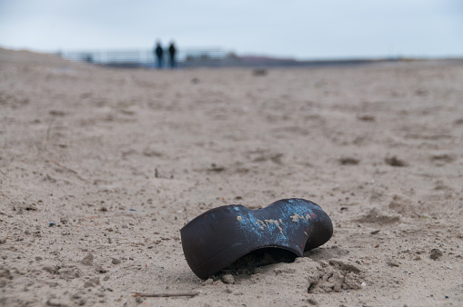 CLose-up of a lost shoe on a beach in the south of the Netherlands.