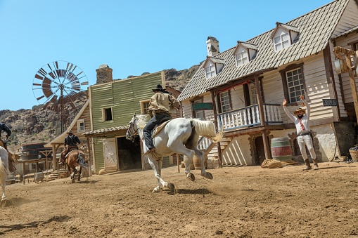 Gran Canaria - April 2023: Step into Sioux City theme park and instantly transform into a cowboy or Indian. Explore the town, witness a thrilling bank robbery and watch the sheriff take on outlaws.