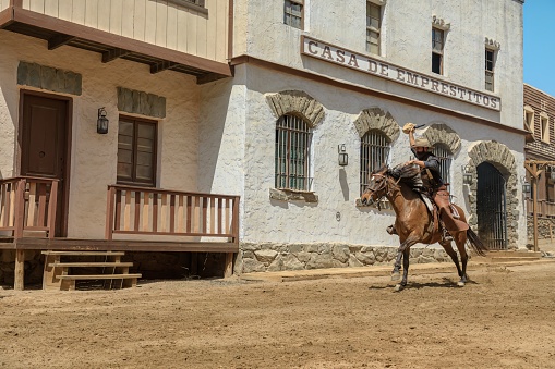 Gran Canaria - April 2023: Sioux City provides an exciting cowboy adventure that includes watching a bank robbery and seeing the sheriff take on outlaws in a realistic wild west town.