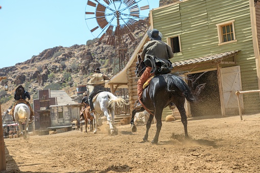 Sioux City Park, Gran Canaria - April 2023: The actors of Sioux City Park play the roles of cowboys, sheriffs, bandits, and other characters, and engage visitors in mock gunfights and other activities