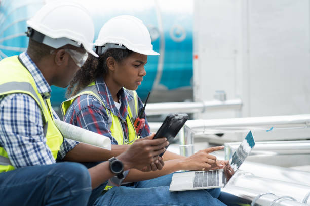 istock Male and female engineer worker working with laptop computer discuss and inspecting structure of building at rooftop of building at construction site 1490662966