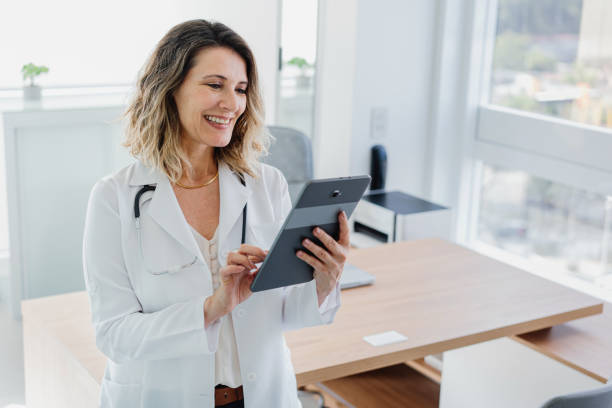 istock Portrait of female doctor using digital tablet smiling 1490665593