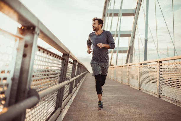 istock Man Running on the Bridge During Sunset 1490666397