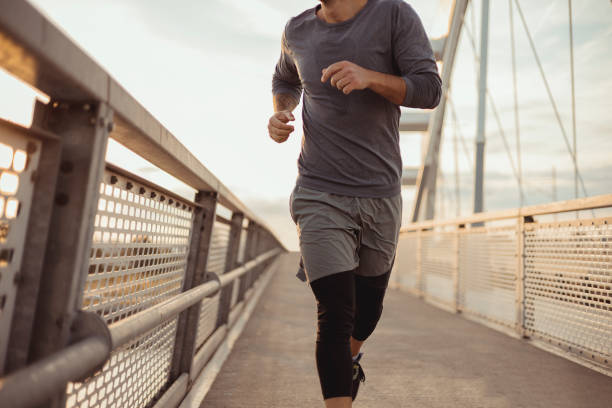 istock Cropped Image of Athletic Man Running 1490666496