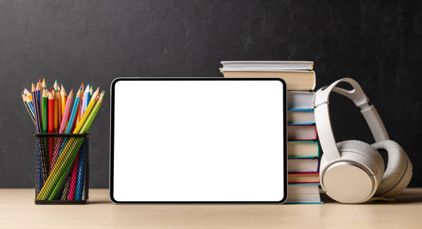 istock Tablet with colorful pencils and stack of books 1490667401