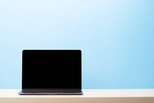 istock Laptop with blank screen on wooden table 1490667794