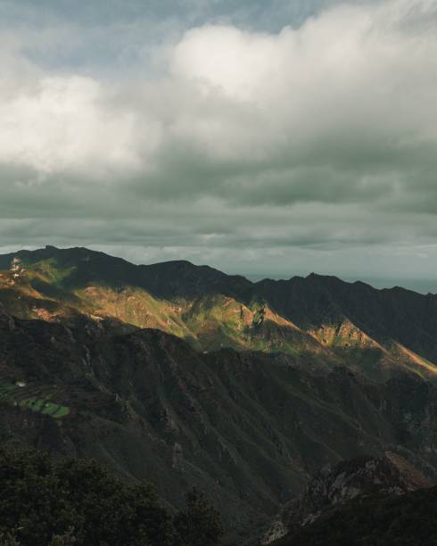 istock Majestic mountain landscape surrounded by lush trees and rolling hills 1490668493