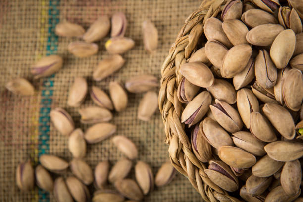 Bowl full of  pistachios on burlap sack
