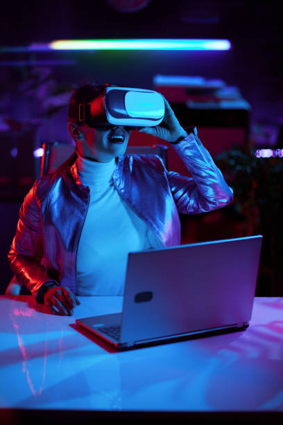 istock smiling stylish female in virtual reality goggles in office 1490669438