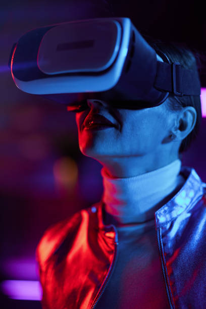 istock elegant woman in vr headset on dark background 1490669453