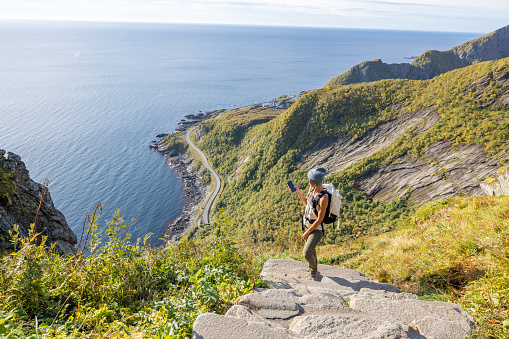 Young woman hiking in a beautiful scenery in Summer walking up the stairs enjoying nature and the outdoors.
Lofoten islands, Norway