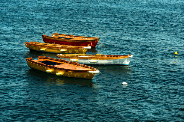 istock bright yellow light on the sides of three boats 1490672678
