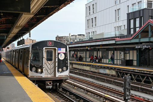 New York, USA, April 11, 2023 - An inbound M line subway train at the Marcy Avenue station. It is a station on the BMT Jamaica Line of the New York City subway and is located at the intersection of Marcy Avenue and Broadway in Brooklyn.