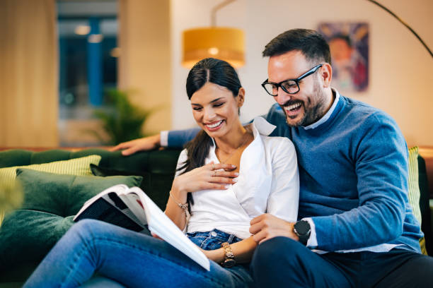 istock Two smiling lovers reading a book, sitting at the workplace. 1490674141