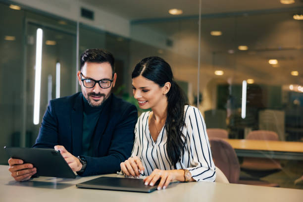 istock Male boss pointing on the next business task to a colleague, using a tablet. 1490674314