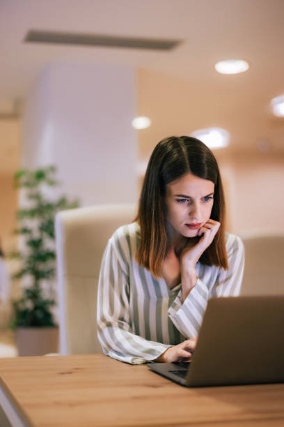 istock Serious businesswoman using a laptop, sitting at the workplace. 1490674680