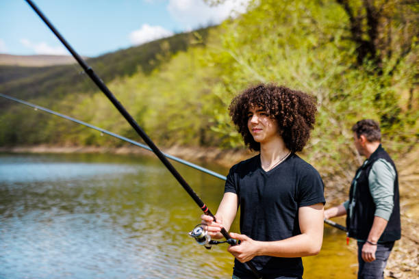 istock Teenage boy learning how to catch a fish 1490674713