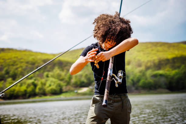istock Teenage boy trying to untangle the string 1490675014