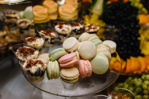 istock Macaroons. Candy bar. Sweet table for celebration party. Cakes with fruit on a festive table in a restaurant. Closeup details. 1490675219