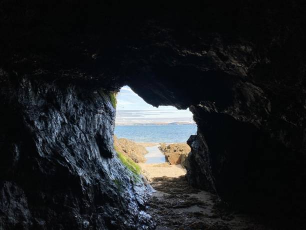 istock View inside a sea cave looking out onto a sandy beach 1490675482