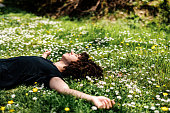 Boy with curly hair enjoys springtime in nature