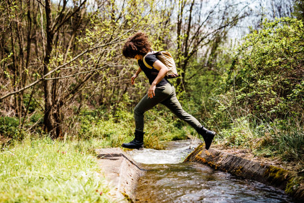 istock Teenage boy jumps over the stream 1490675784