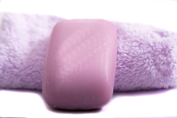 brown towel and shower gel on a gray background. face cream and towel on the table. Cosmetics SPA branding layout. Folded cream and bath towels on a white background.