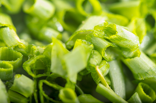 chopped green onions. Eds background is a green onion. Green Perya onion cut for freezing. Background from the cut bow