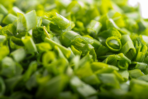 chopped green onions. Eds background is a green onion. Green Perya onion cut for freezing. Background from the cut bow