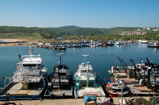 Kyky harbor with many fishing vessels and boats in spring day