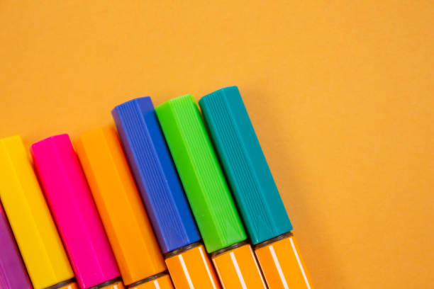 istock Colorful markers on orange background 1490678588